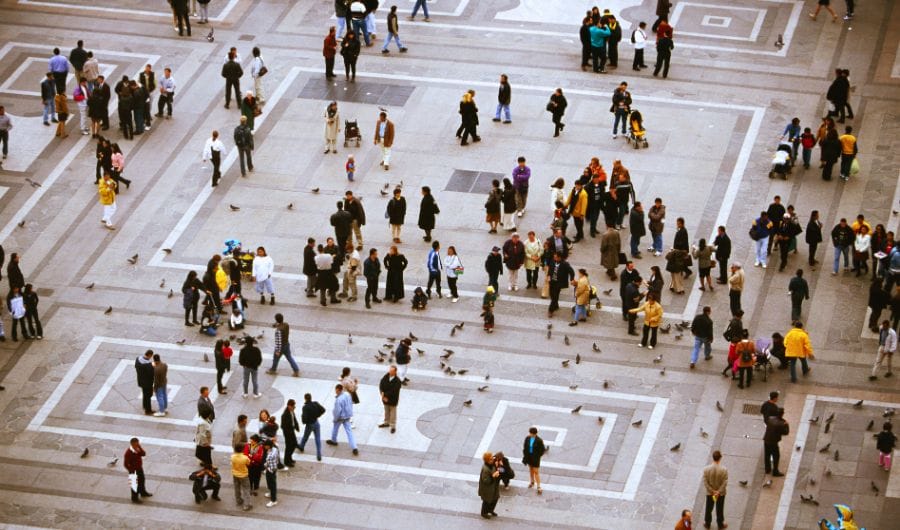 aerial view of a large, open public square with numerous people walking and standing