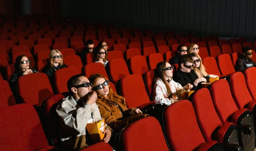 People wearing a 3D glasses to while watching a movie