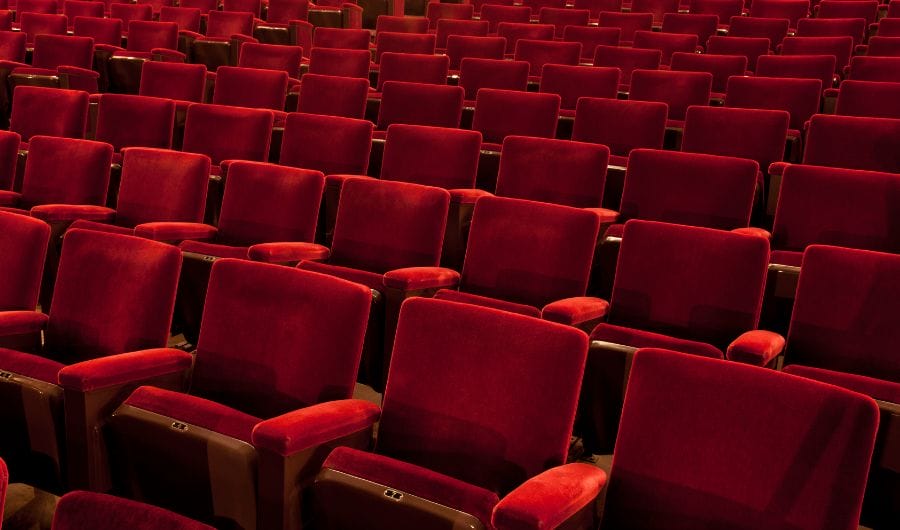 Red seats inside a theatre
