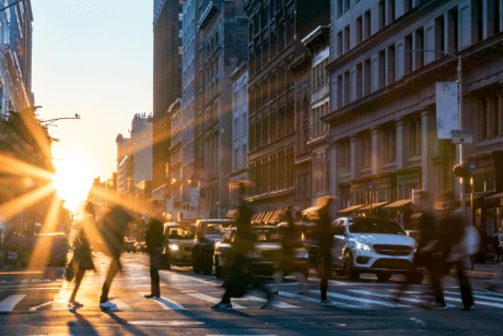 People crossing a busy street crossing