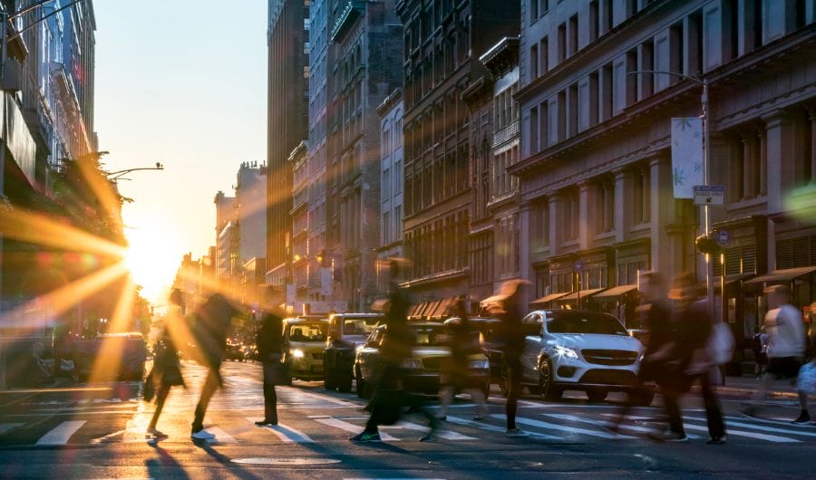 People crossing a busy street crossing