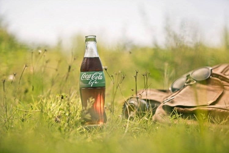 Coca Cola in a field of green